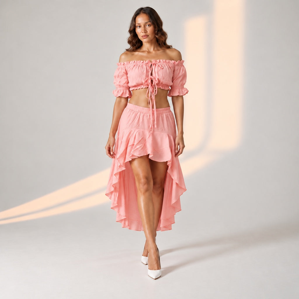Pink high-low skirt set. Pink off-shoulder crop top. Women's pink co-ord outfit. Pink asymmetric maxi skirt. Pink two-piece party outfit. Pink vacation wear for women. Pink occasion wear for women. Stylish summer outfit. Pink holiday clothing. Feminine boutique outfit. Pink statement skirt. Chic women's clothing. Pink evening outfit. Modern co-ord set. Marcel and Mae co-ord.
