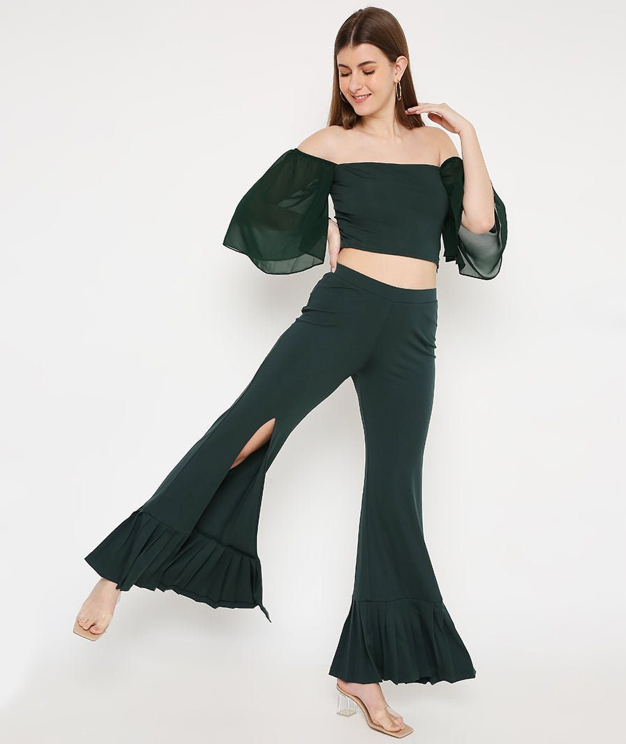 Back view green bell sleeve crop with pleated bottoms
