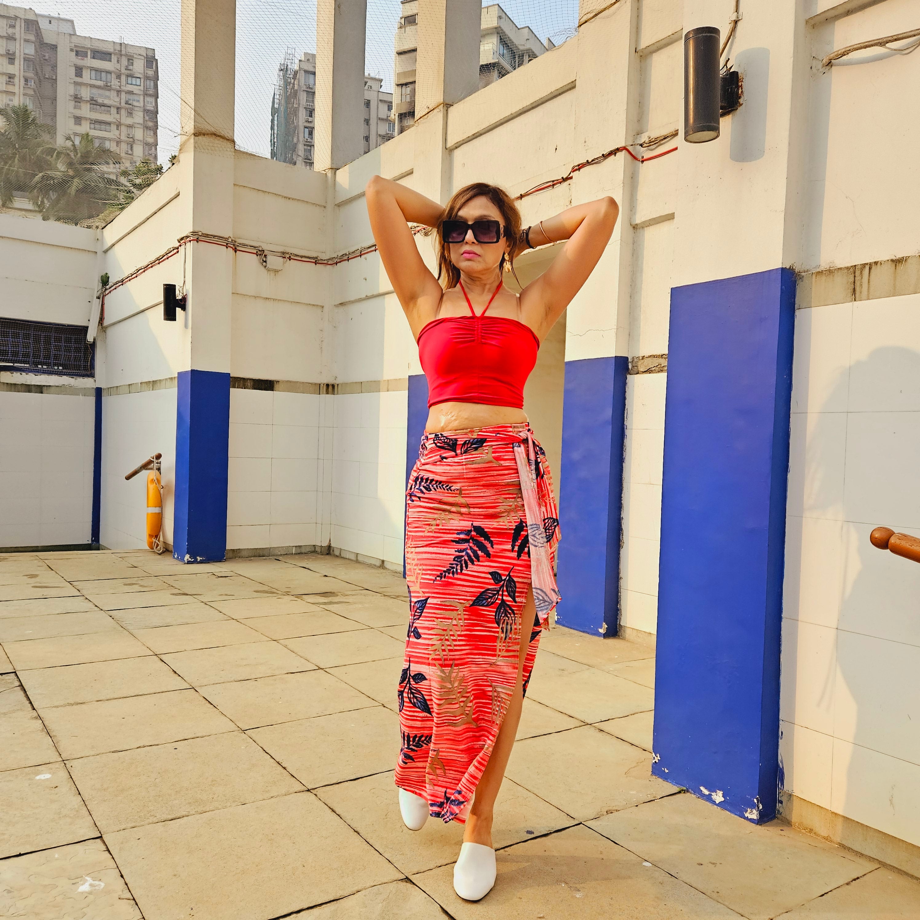 Red Bamboo Print Front Knot Midi Skirt styled for party and vacation – slit movement shot
