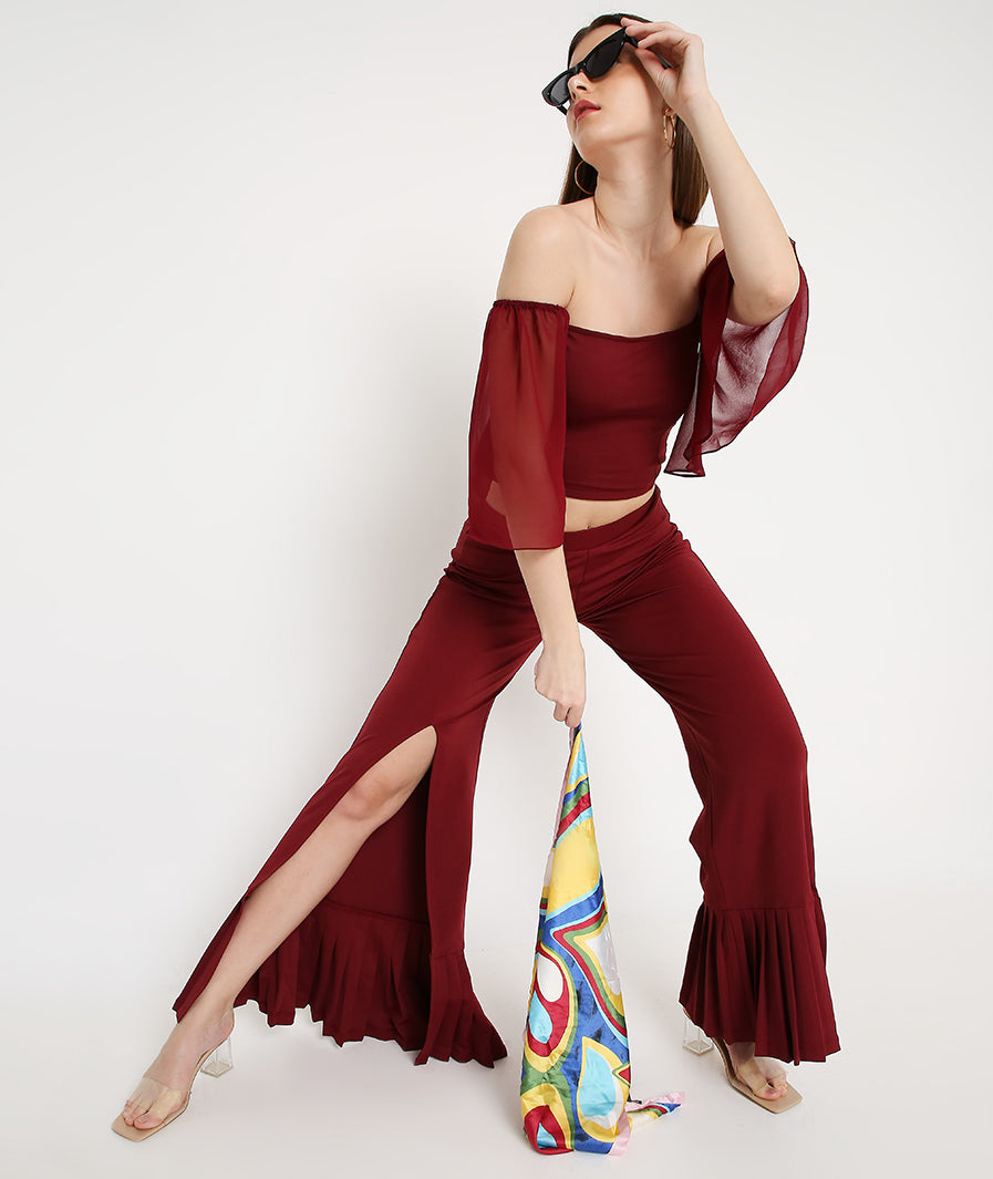 Back view red bell sleeve crop with wine pleated bottoms
