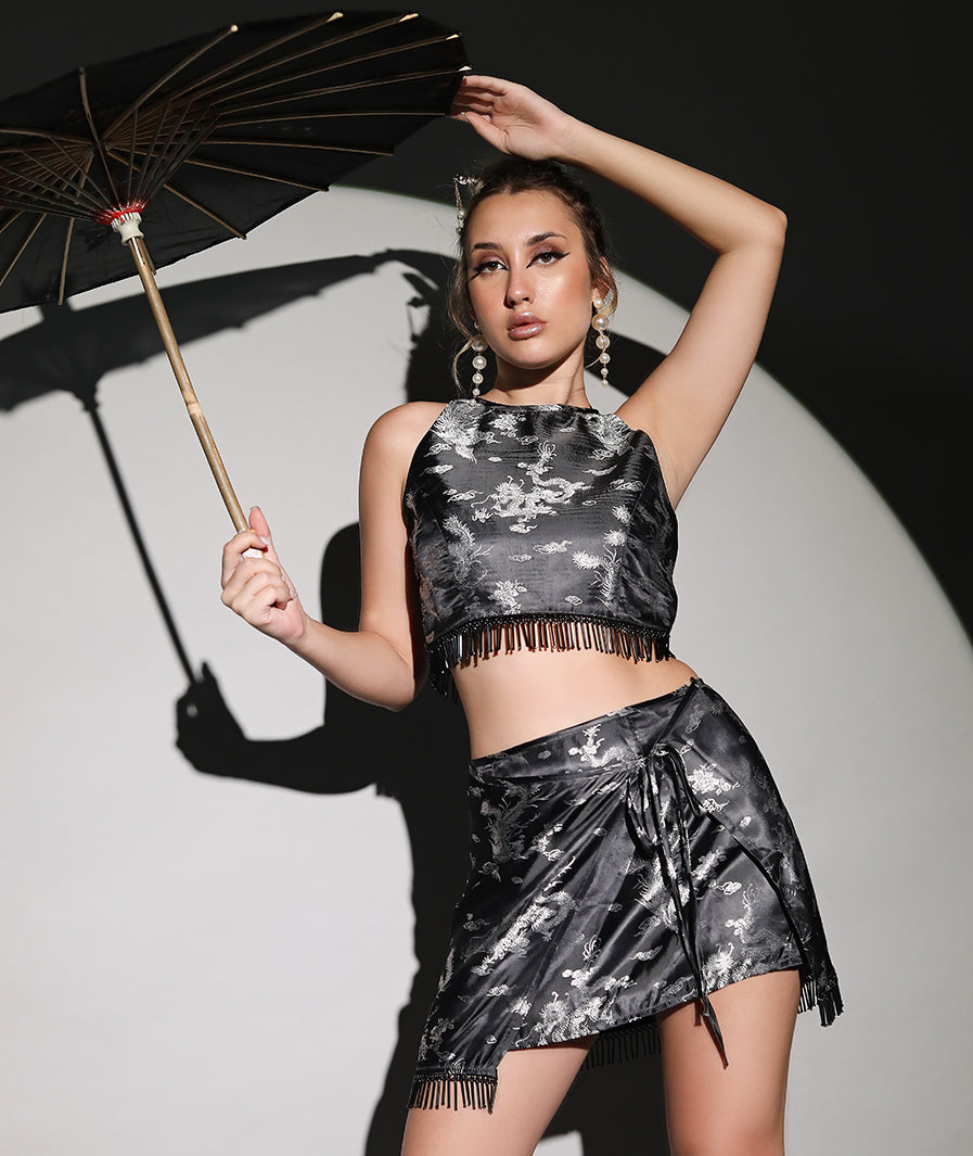 Dragon motif close-up on silver satin beaded co-ord – Marcel & Mae
