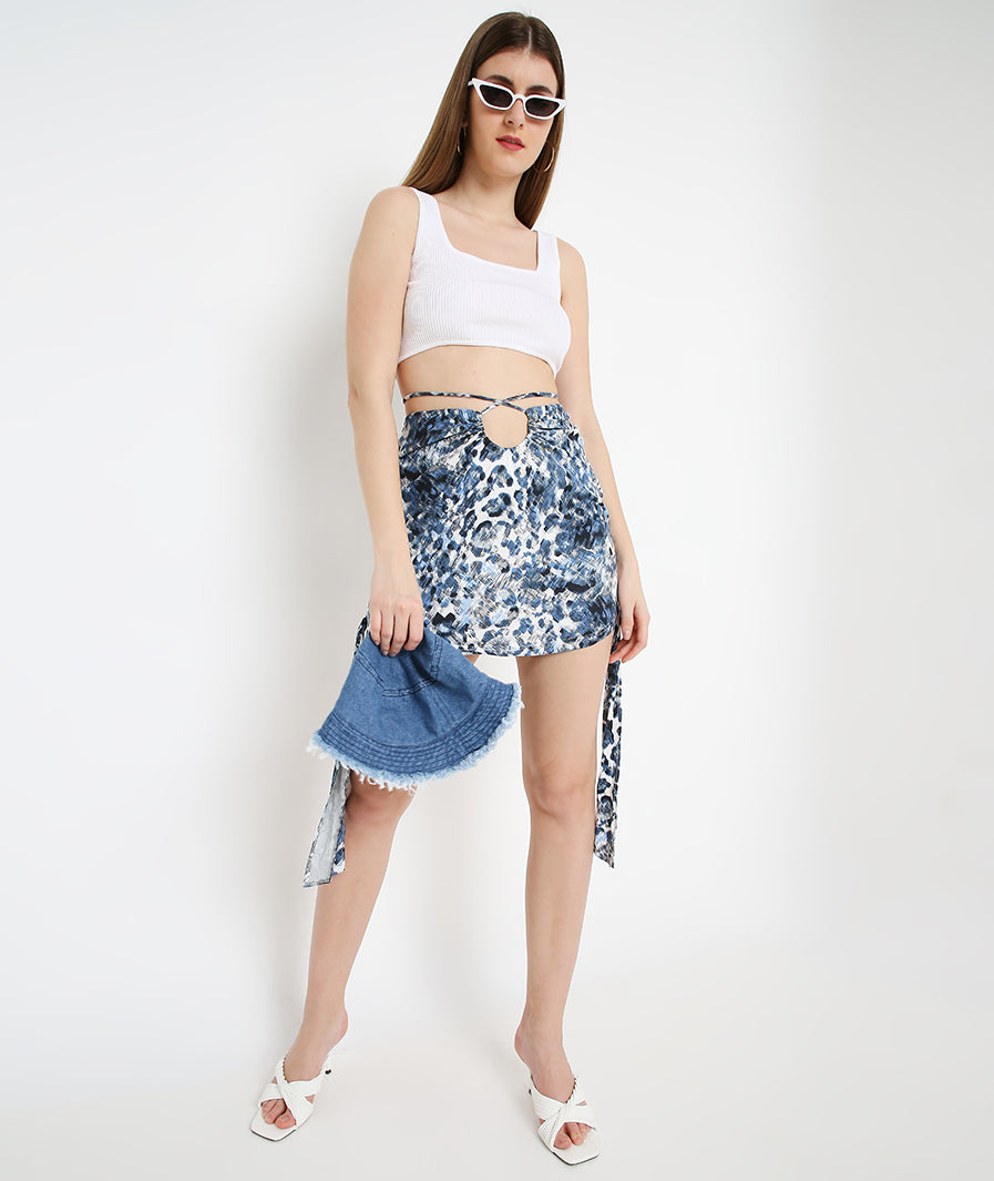 Marcel & Mae Blue Animal Print Cut-Out Skirt, seated pose, blue skirt
