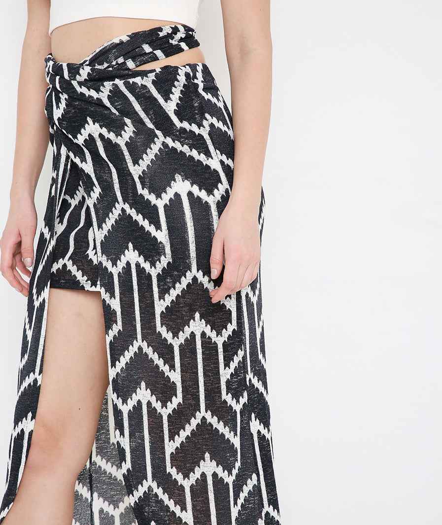 Tie-up detail on black arrow skirt with grey crop top set
